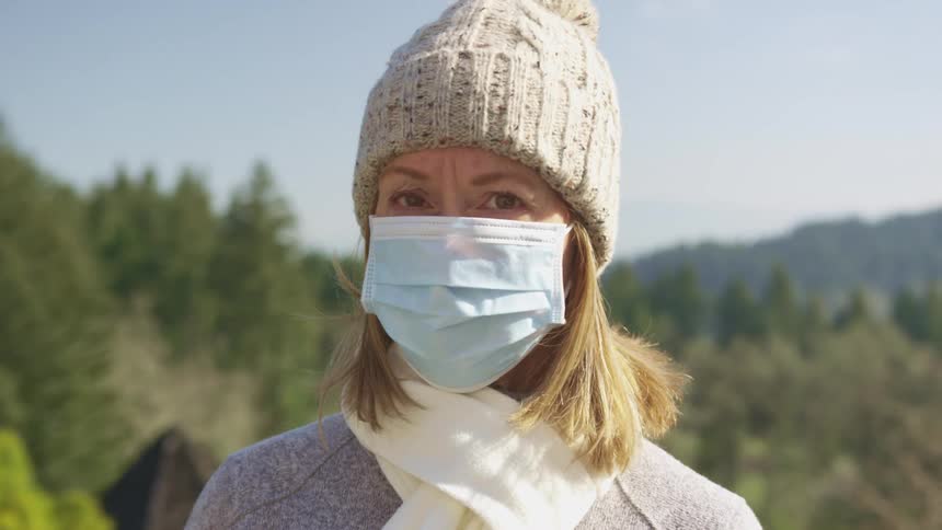 A woman outside with a mask on