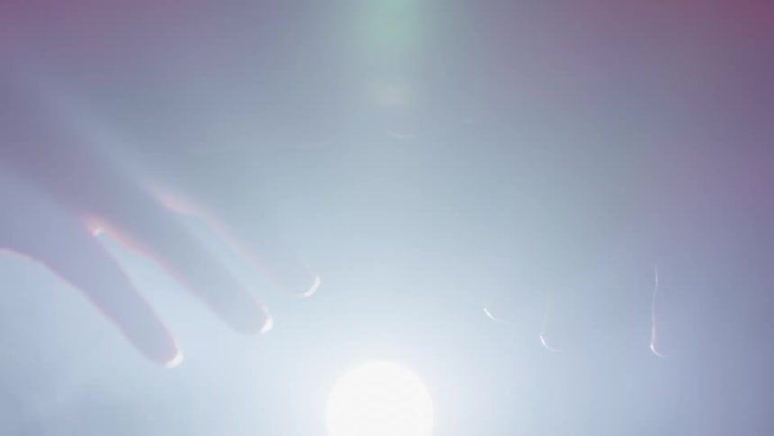 A light is flashing on two peoples hands touching