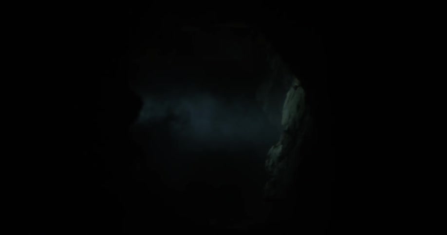 A flashlight shines outside at night