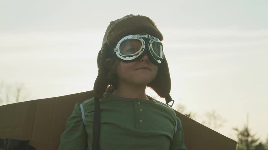A boy is wearing a costume with cardboard wings