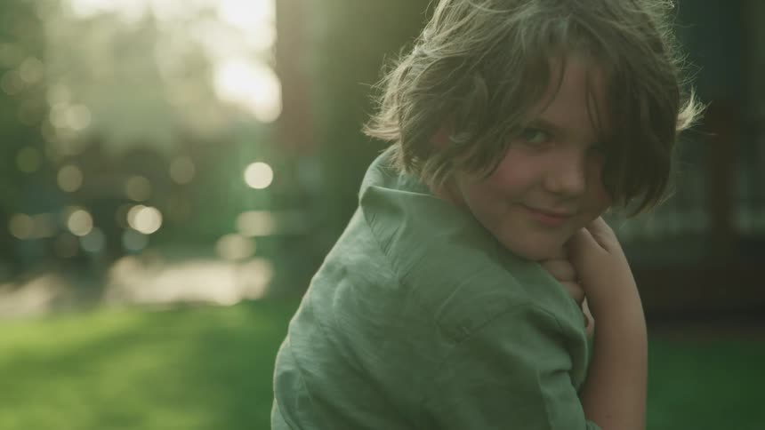 A little boy smiling outside