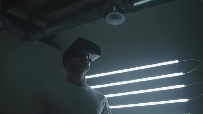 A man is using a virtual reality headset