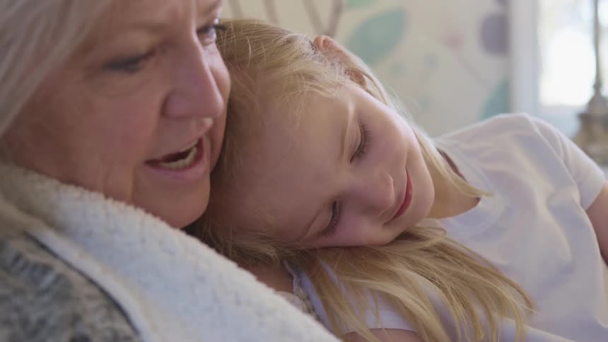 A grandmother is talking to her granddaughter