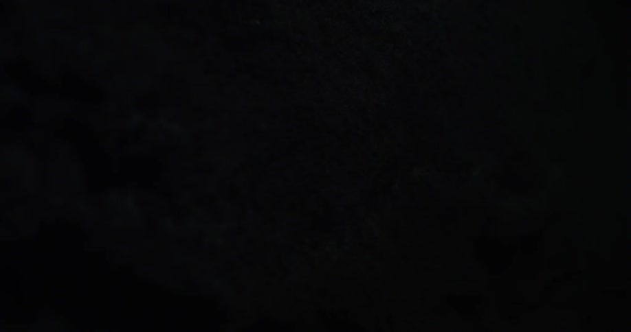 A single light flashes in a dark cave
