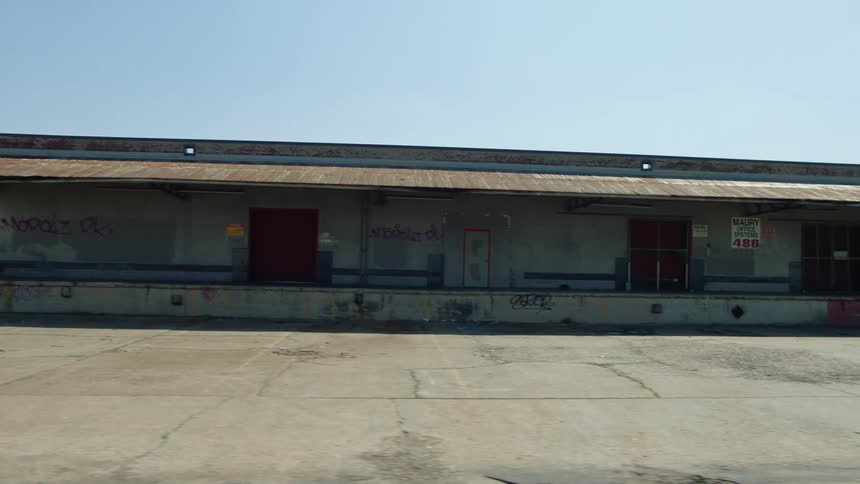 The exterior of a warehouse on a clear day