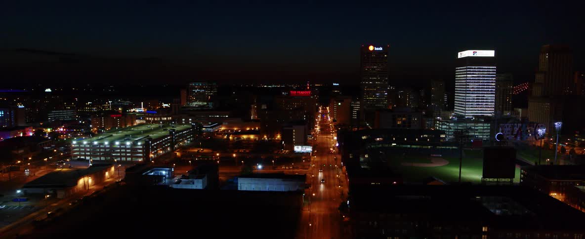 Aerial view of a city skyline with skyscraper and cars driving