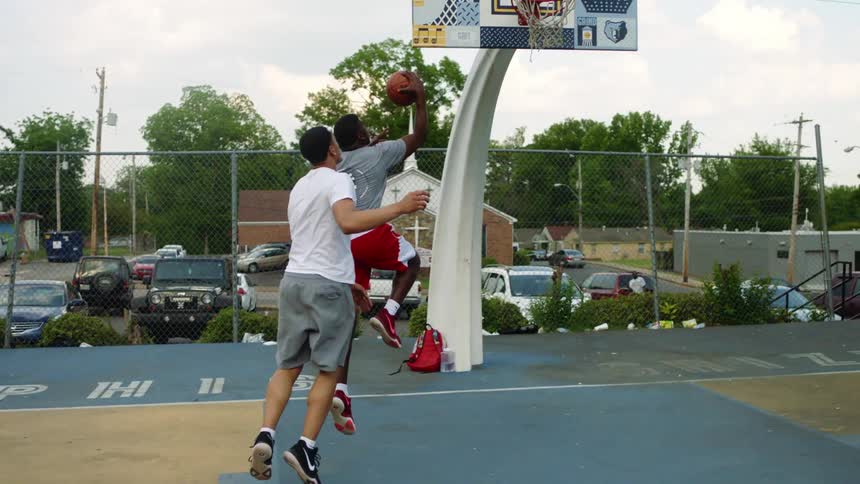 People are playing a game of basketball