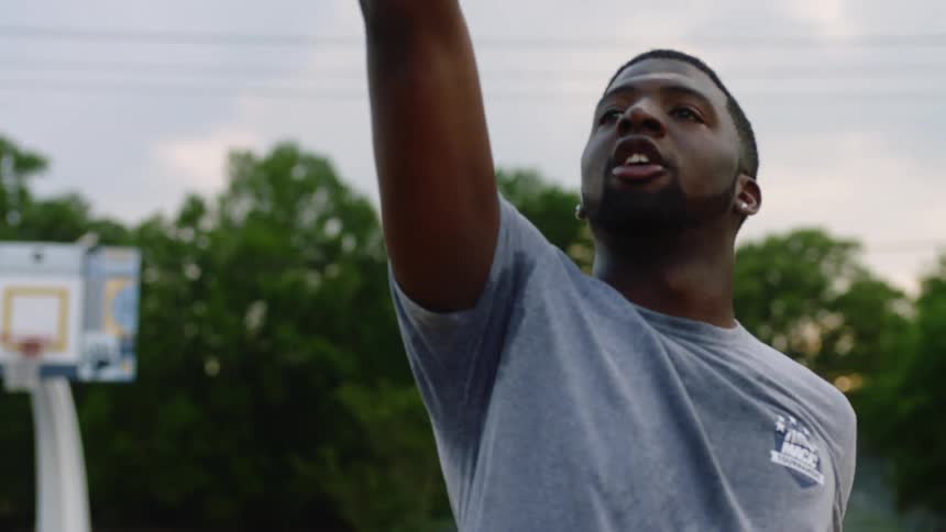 A man shooting a basketball