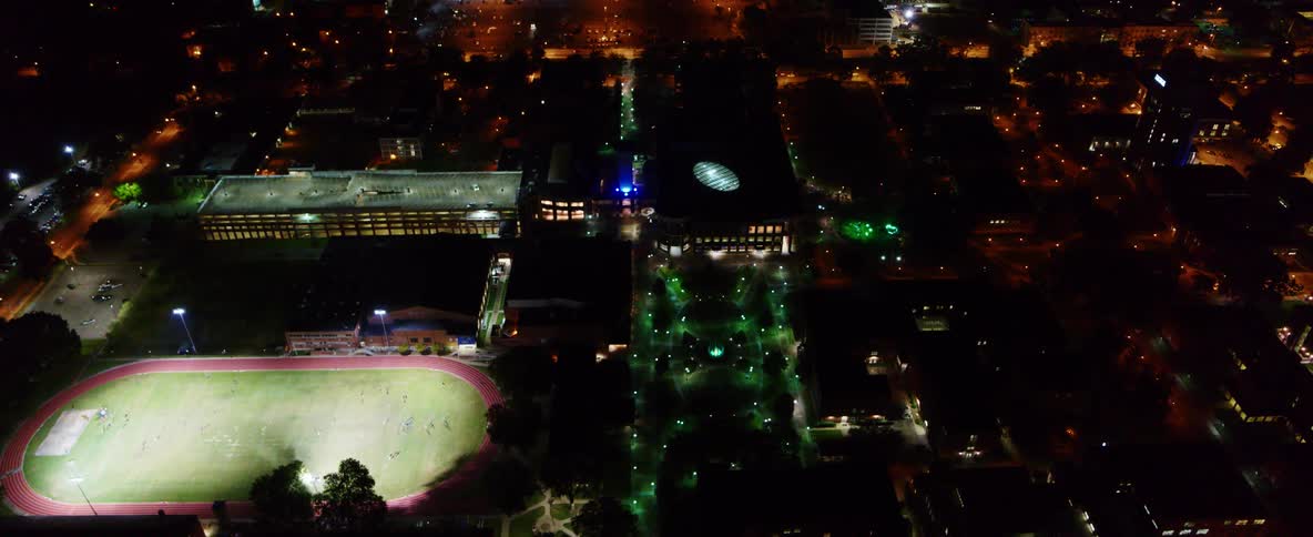 An aerial view of a city with an arena and buildings