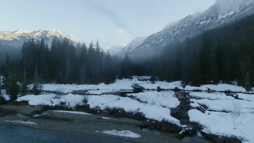 Skimming over a crystal clear stream and rising to reveal a beautiful misty mountain valley