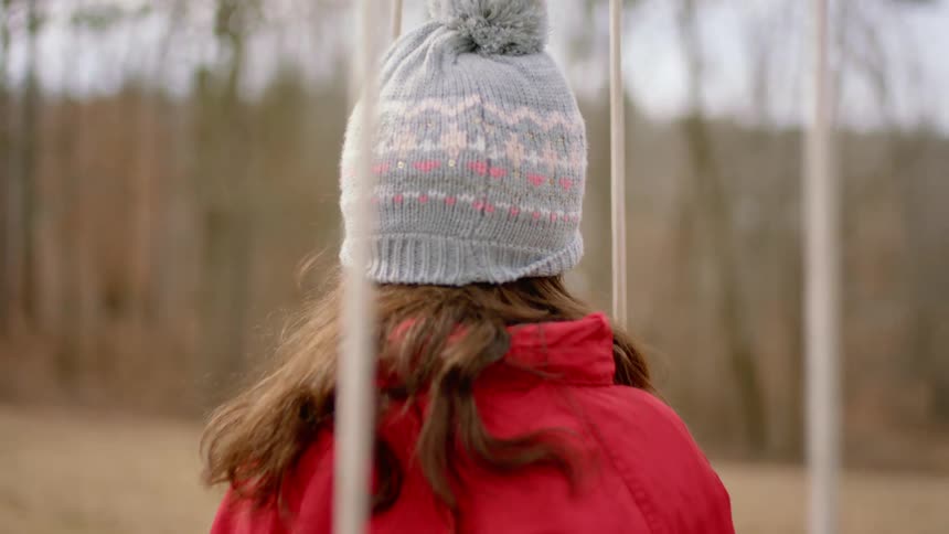 A girl swinging outside