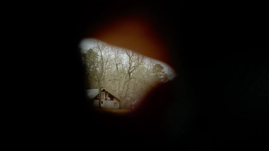 Old farm house and shed bordered by leafless trees and brown tinted grass show through moving size and shape morphing viewport