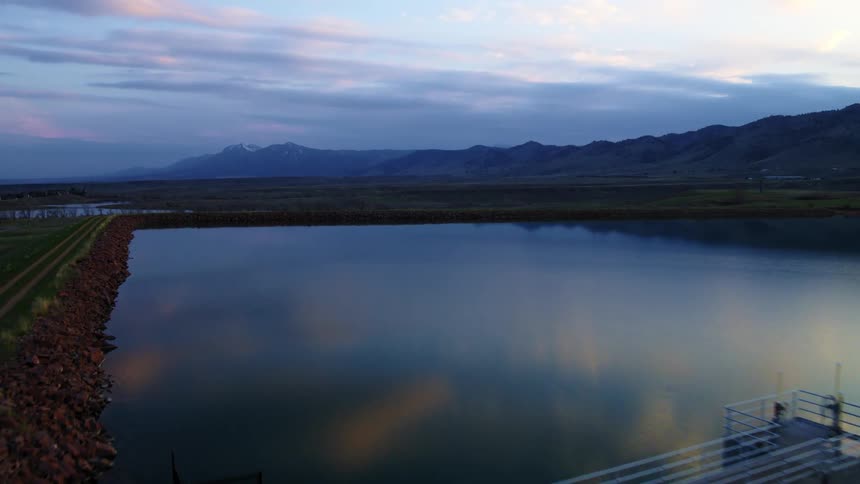 A river and mountains near land and vegetation