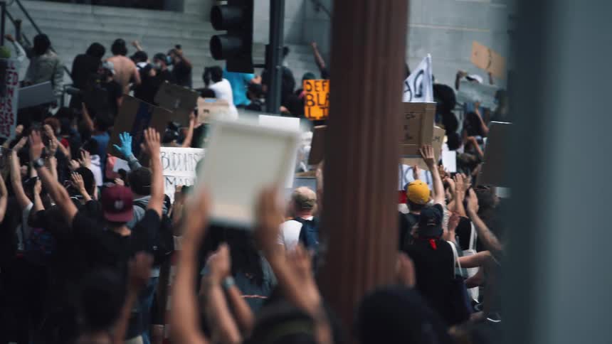 A large group of people gather at a protest