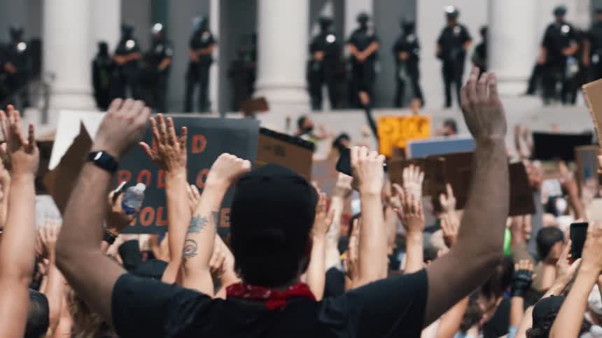 A group of activists holding up signs at a black lives matter protest
