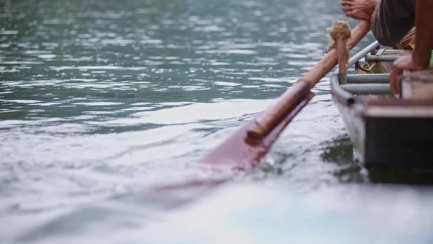 People travel across a lake in a rowboat