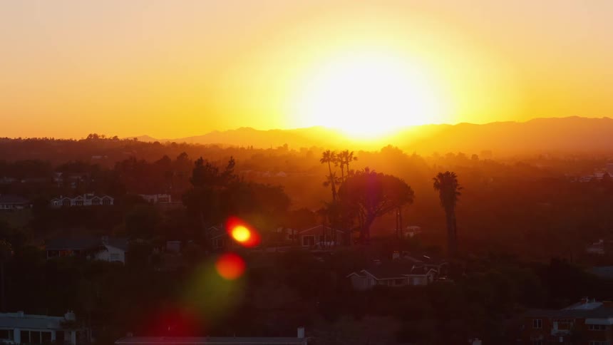 The sun setting over the horizon
