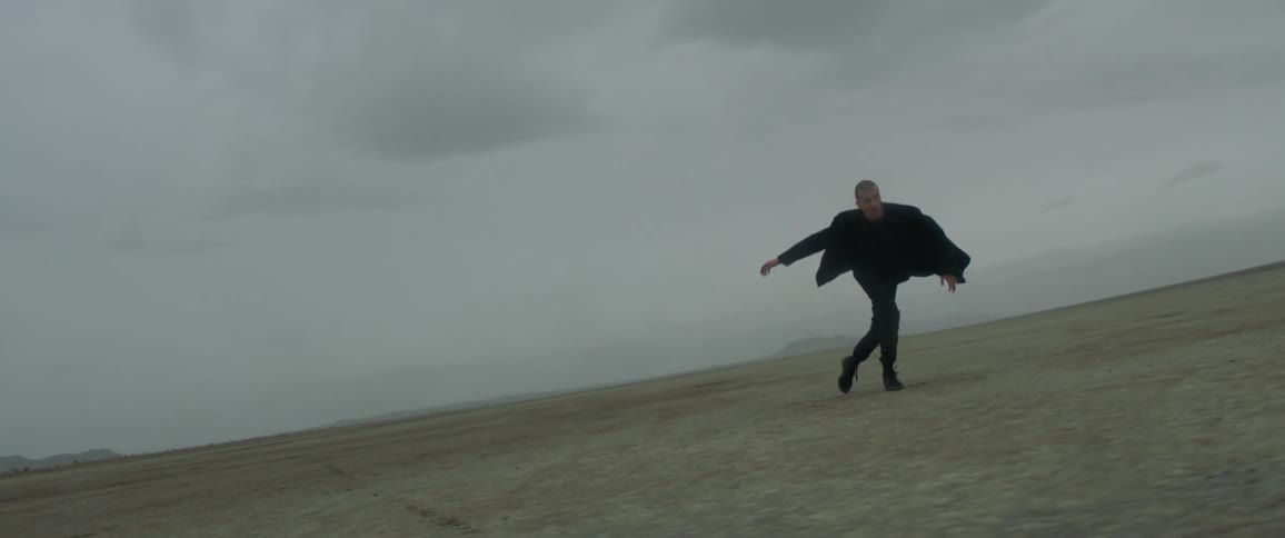 A man is stumbling around on the flat field