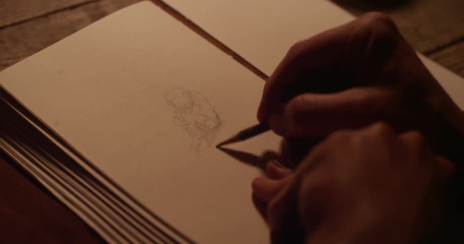 Person sketching on paper