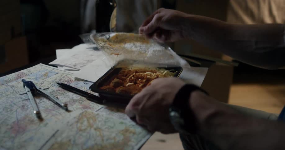 A man starts eating his tv dinner