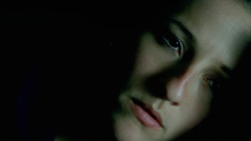 A woman is resting in the dark