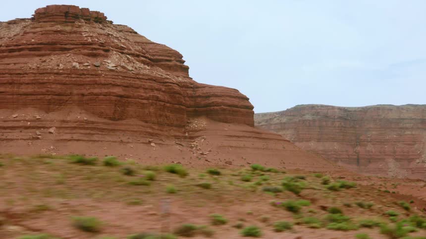 Red rock formations in a desert in the daytime