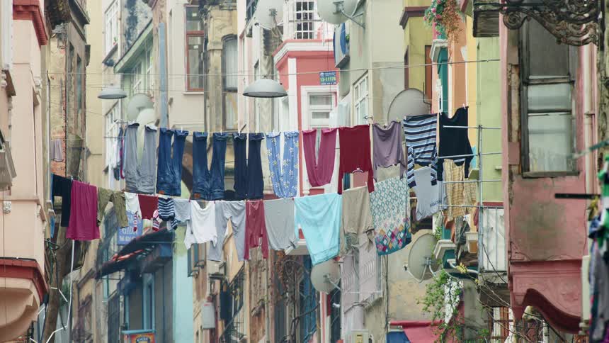 Clothes hang from clotheslines strung between buildings