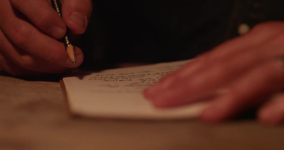 A man writing in a book