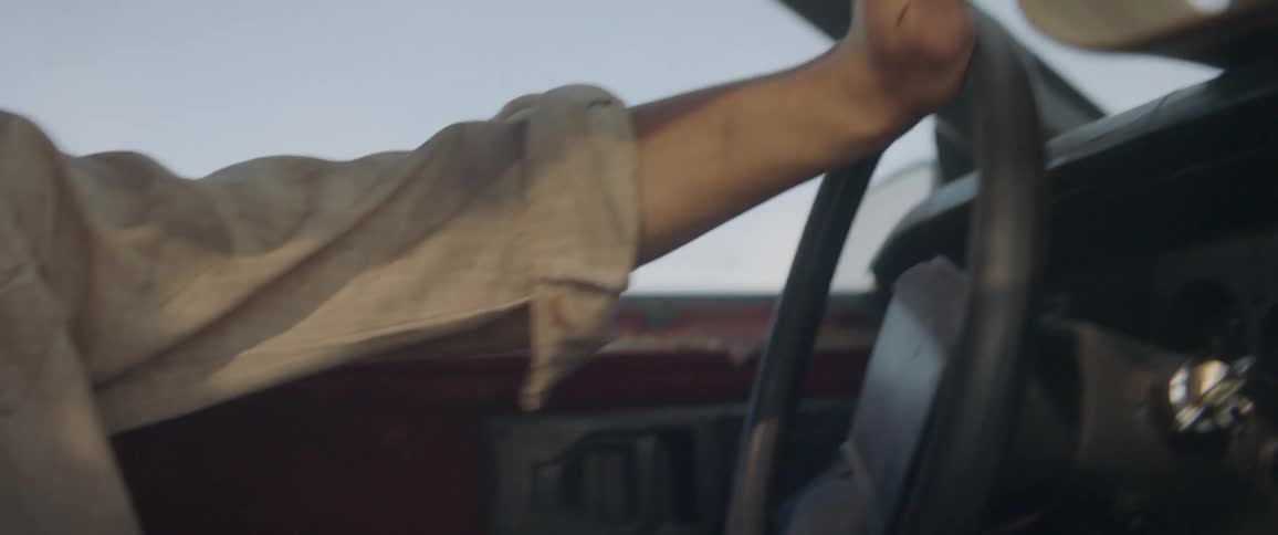 A man steers a car frantically