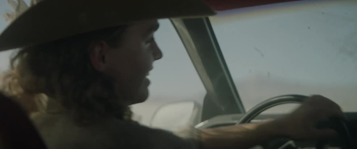 A woman frantically drives a car in circles