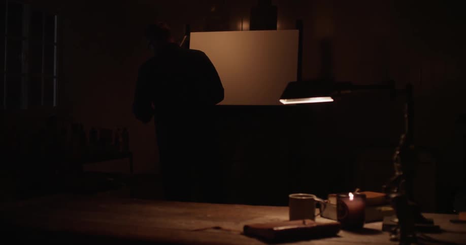 A person is writing in a notebook on a desk