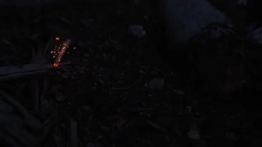 A lit cigarette falls to the ground