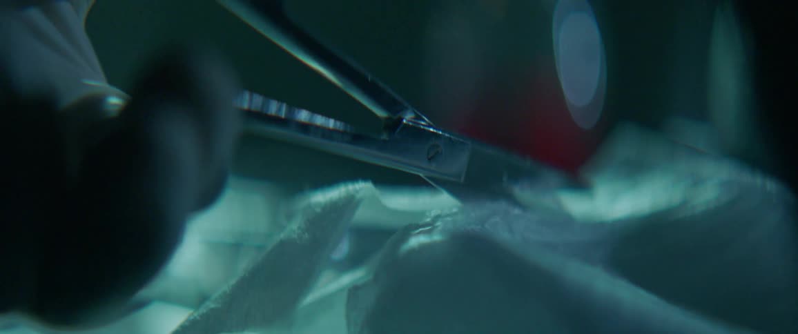 A person is using scissors to cut cloth tape