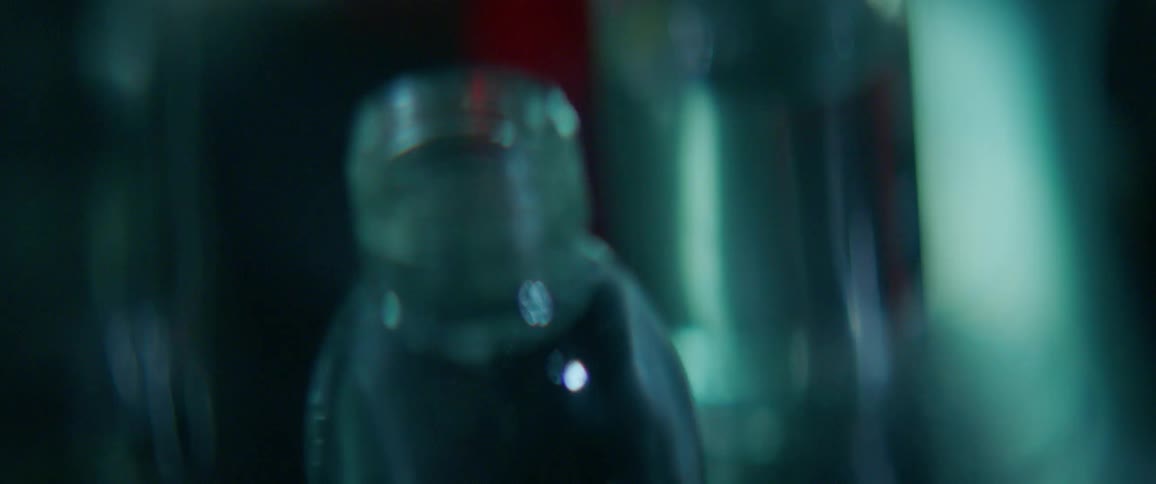 Glass bottles containing liquid are sitting on a surface