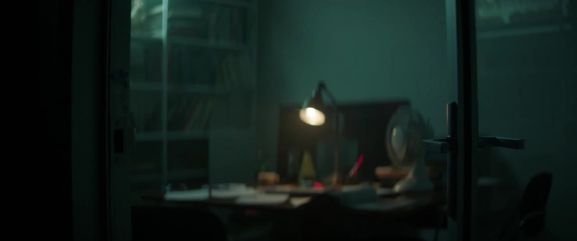 A lamp shines on a desk