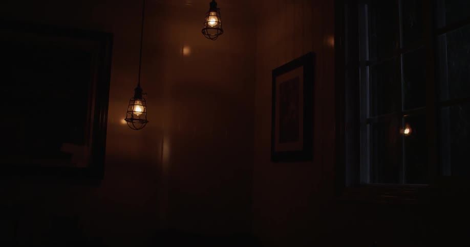 Light bulbs shine indoors at night