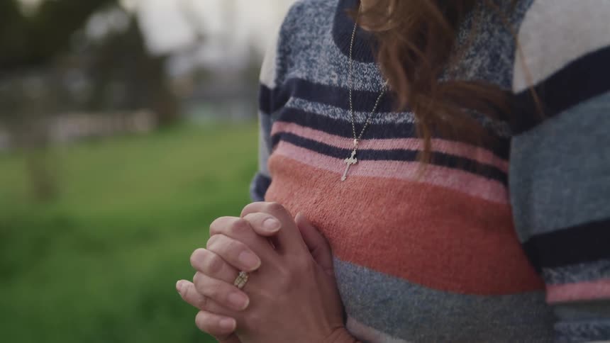 A woman praying outside