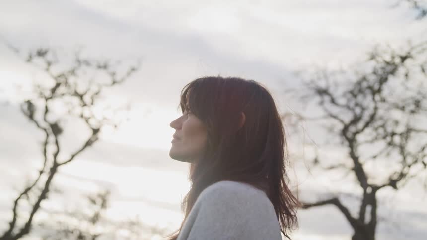 A woman is standing outdoors