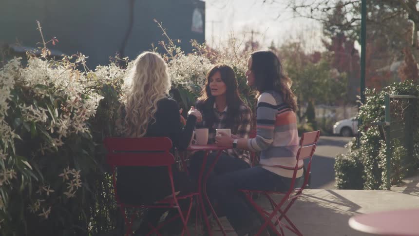 Woman having coffee on outside patio