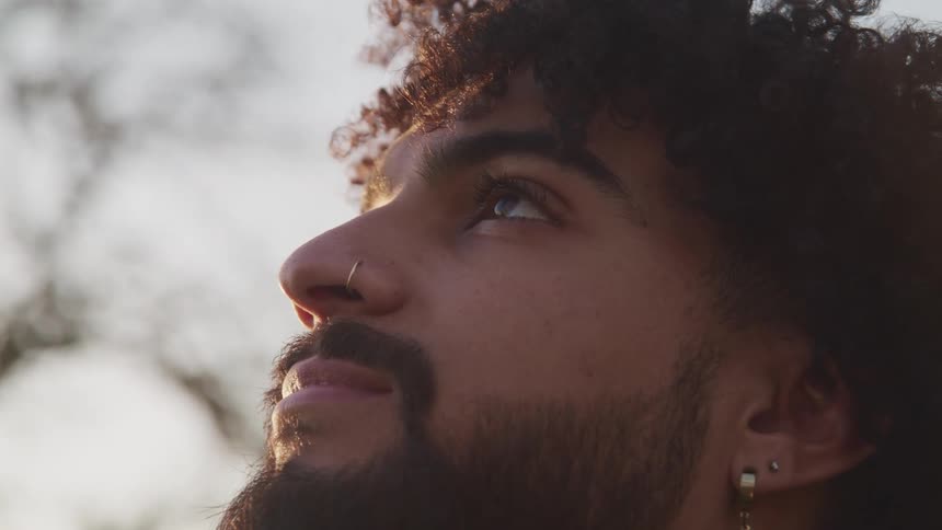 A man is looking up at the sky