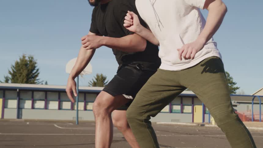 Two men playing basketball together