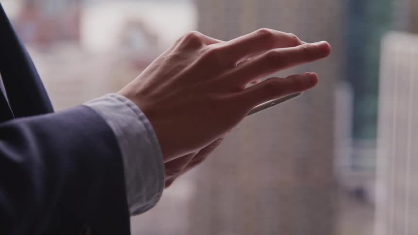 Businessman in suit uses a tablet in the office