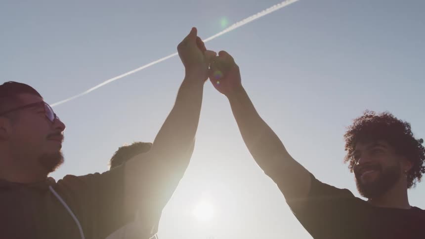 Three friends are hanging outdoors together