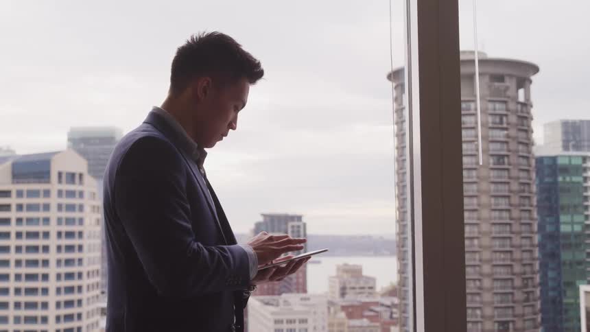 A man is using his tablet in the office