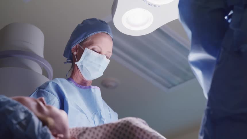 Surgeons work on a patient