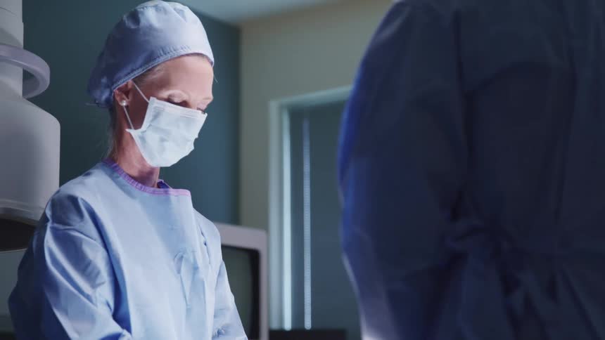 Surgeons operating in a hospital operating room