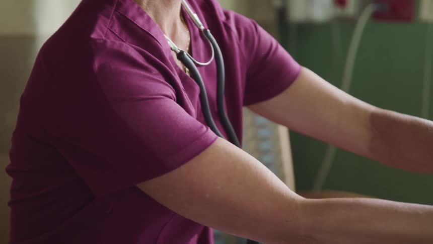 A nurse adjusting equipment