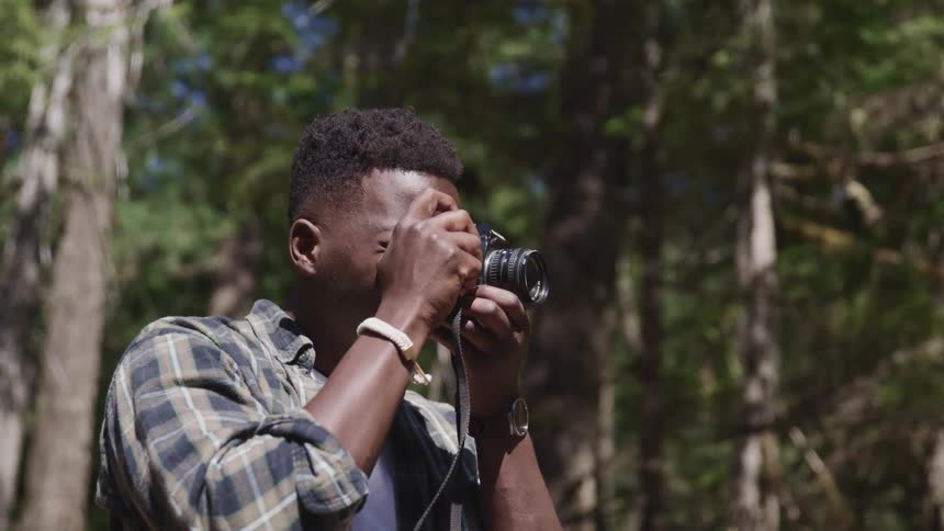 A man is photographing in the forest