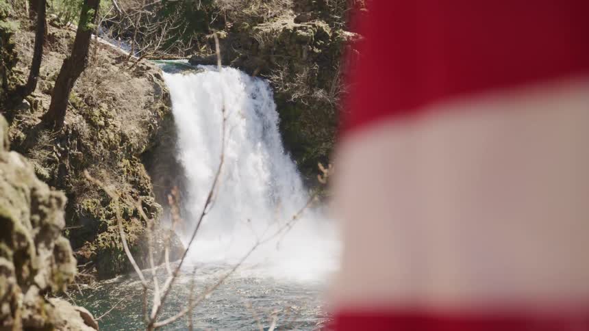 The waterfall flows into the stream