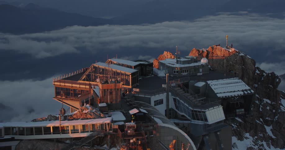People on a large observation deck on top of a mountain